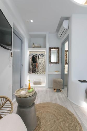 a room with a table and a walk in closet at Majestique of Naxos luxury suites in Naxos Chora
