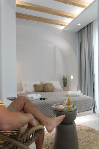 a person with their feet on a pot in a bedroom at Majestique of Naxos luxury suites in Naxos Chora