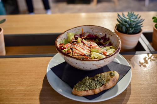 a bowl of food on a plate on a table at Central Inn in Zlatibor