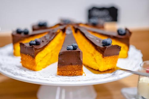 a plate with three pieces ofecake with chocolate and blueberries at Urban Boutique Hotel Center in Ljubljana