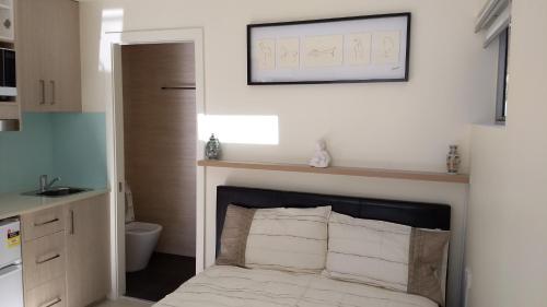 a bedroom with a bed with a fireplace in it at Randwick City Lodge 2 in Sydney