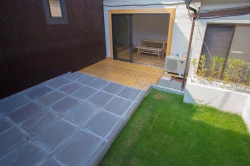 a backyard with a patio with a bench and a table at I Osaka Traditional in Osaka