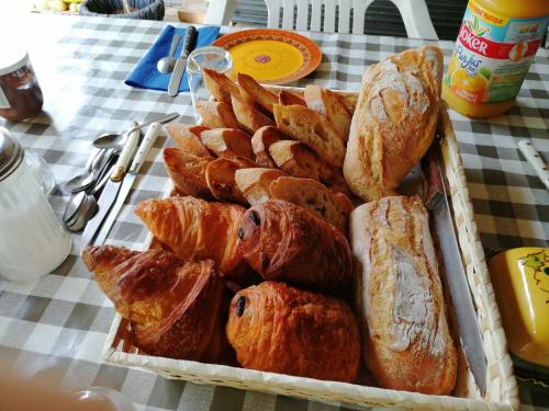 a tray of bread and pastries on a table at L accueillante B&B in Bédarieux