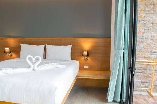 a bedroom with a bed with two swans on it at Field-D House in Koh Tao