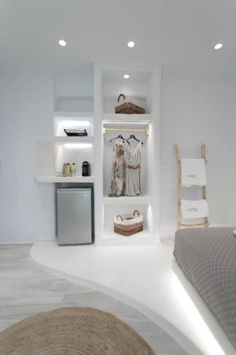 a bedroom with white walls and white shelves at Majestique of Naxos luxury suites in Naxos Chora