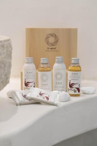 four bottles of milk sitting on a table with a box at Majestique of Naxos luxury suites in Naxos Chora
