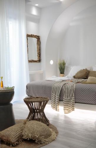 a white bedroom with two beds and a rug at Majestique of Naxos luxury suites in Naxos Chora