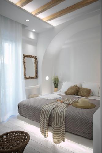 a white bedroom with a large bed in a room at Majestique of Naxos luxury suites in Naxos Chora