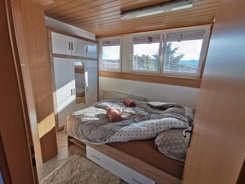 a bedroom with a bed in a tiny house at Pohorje in Spodnje Hoče