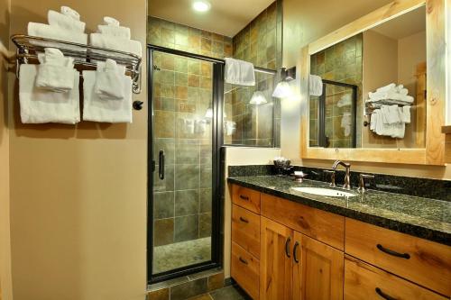 a bathroom with a shower and a sink at Big Sky Resort Village Center in Big Sky