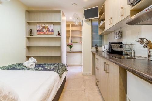 a kitchen with a bed and a counter top at Randwick City Lodge 2 in Sydney