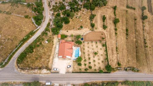 an overhead view of a farm with a house and a road at Holiday Home Melone in Lećevica