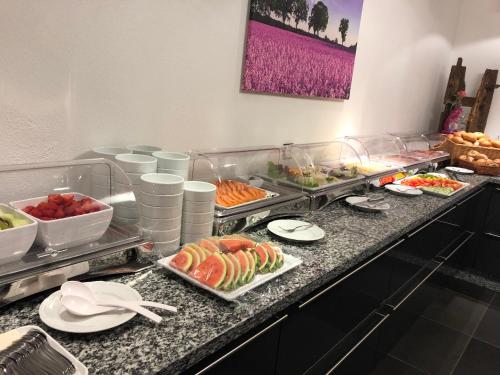 a buffet with many different types of food on a counter at Hotel Rieder in Wiesemscheid