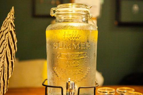 a glass jar of beer sitting on a table at Fukuoka Guesthouse HIVE in Fukuoka