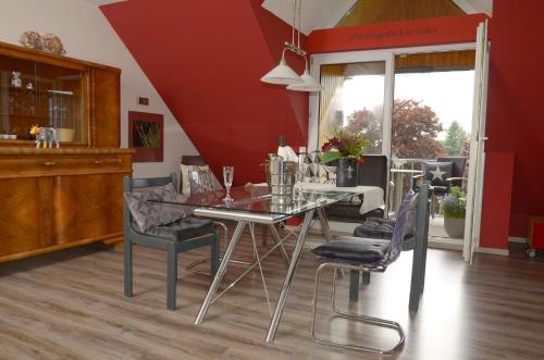 a dining room with a glass table and chairs at Ferienhaus Luzia in Darscheid