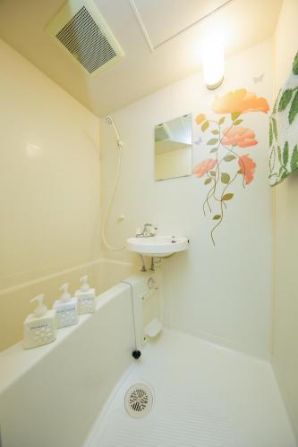 a bathroom with a sink and a toilet at Cozy house 8, free wifi a rented electric bicycle in Kyoto