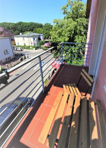 a porch with a bench on a balcony at Willa Park Międzyzdroje in Międzyzdroje