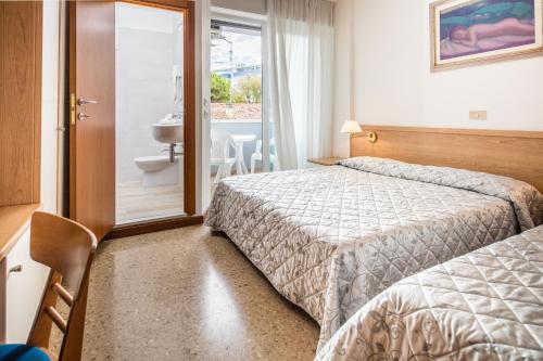 Postel nebo postele na pokoji v ubytování Hotel Meublè Zenith