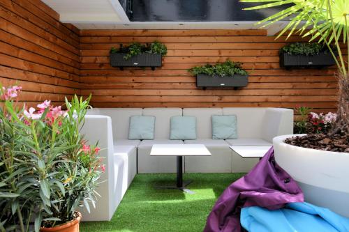 a patio with a white couch and some plants at ibis Lyon Gare Part Dieu in Lyon