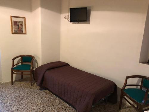En eller flere senger på et rom på Al Podere del Nonno Romolo