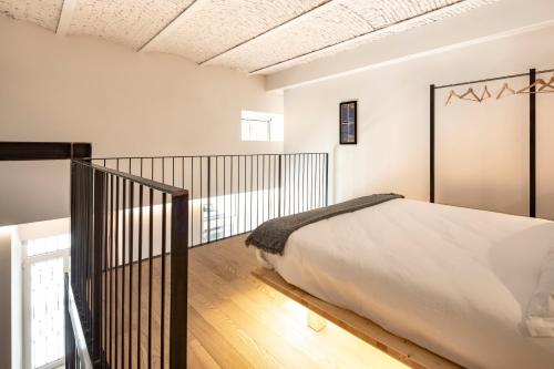 a bedroom with a large bed and a balcony at Design Loft Corte Kalister in Trieste