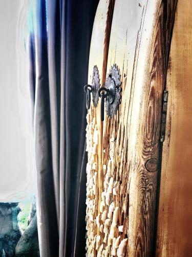 a surfboard hanging on a wall next to a curtain at HemDem Alçıtepe in Canakkale