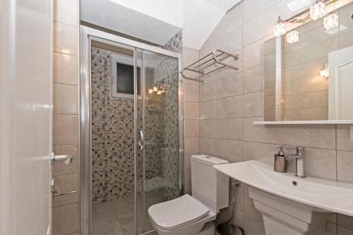 a bathroom with a toilet and a sink and a shower at Casa di VaLL in Ohrid
