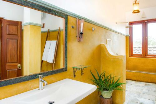 a bathroom with a sink and a mirror at Villa Rosa in Kandy