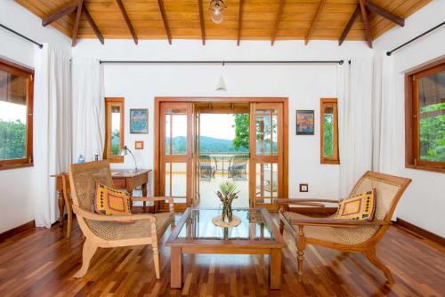a living room with a table and chairs at Villa Rosa in Kandy