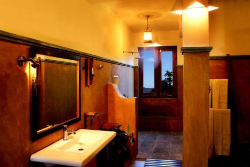 a bathroom with a white sink and a shower at Villa Rosa in Kandy