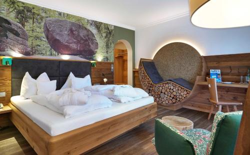 a bedroom with a bed with pillows on it at Hotel Lindenhof in Kellberg