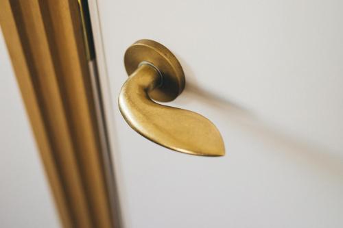 a brass door handle on a door at Hotel Noum OSAKA in Osaka