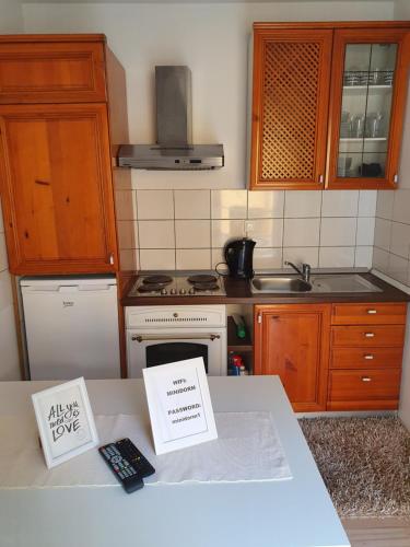 a kitchen with wooden cabinets and a counter top at MINIDORM ROOMS IN HEART OF CITY CENTER in Maribor