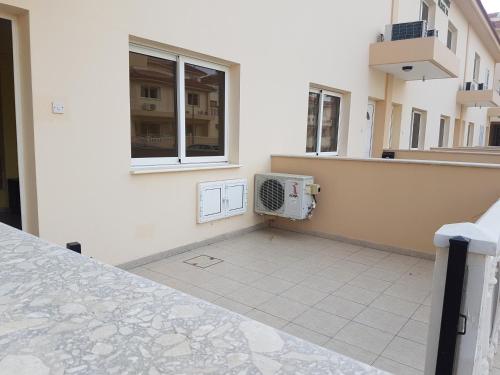 a balcony with a washing machine on the side of a building at Lovely holiday home,Kapparis,2 swimming pools,Wifi in Paralimni