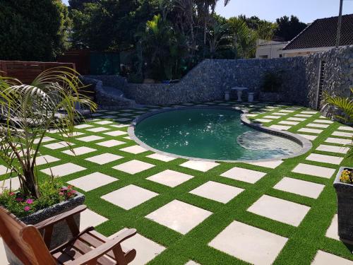 a swimming pool in the middle of a yard at Reef View BnB in East London