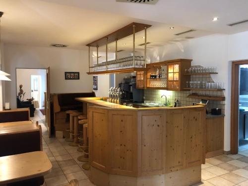 a kitchen with wooden cabinets and a counter top at Ennstalerhof in Grossraming