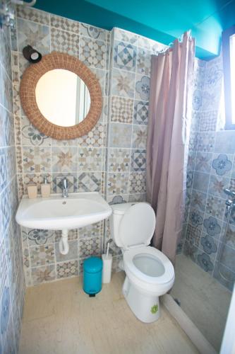 a bathroom with a toilet and a sink and a mirror at Joanna's studio (Rafina port) in Rafina