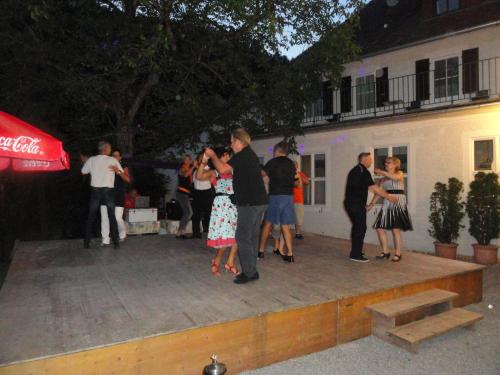 a group of people dancing on a patio at night at Ennstalerhof in Grossraming