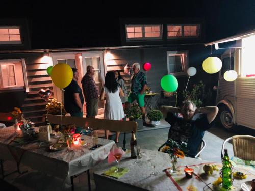 a group of people standing in a yard with balloons at Tinyhaus Wolkenlos Familie Hamdorf in Bad Sulza