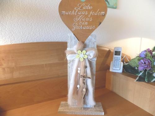 a wooden heart with a bride and groom sign on a table at Haus Alexandra in Schöneberg