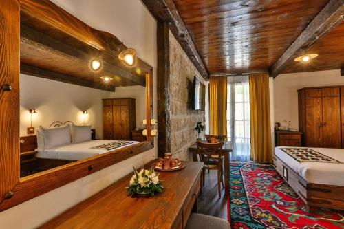 a hotel room with two beds and a mirror at Stara Čaršija Hotel & SPA in Bar