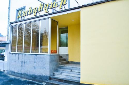a building with a sign on the front of it at Zangezur Hotel in Goris