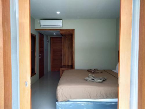 a bedroom with a bed in a room at Hastina Hotel Lombok in Mataram
