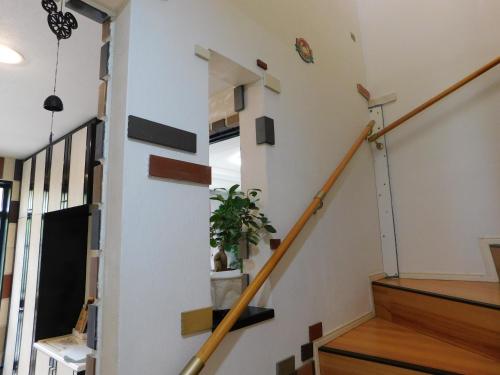 a staircase in a house with a plant at Guesthouse Shang in Toride