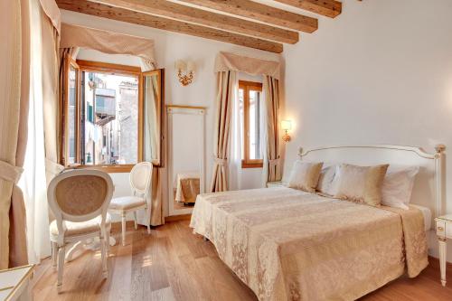 ein weißes Schlafzimmer mit einem Bett und einem Fenster in der Unterkunft Nikki House in Venedig