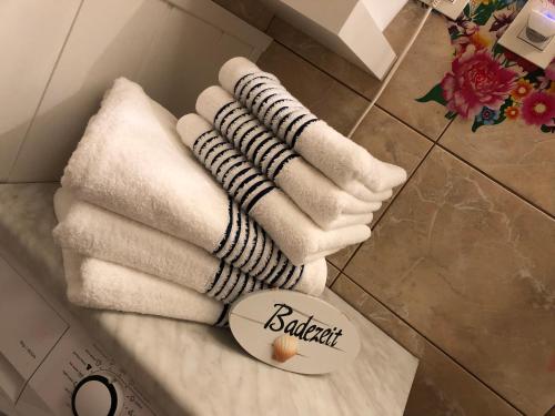 a pile of towels sitting on the floor in a bathroom at Terrace apartment s 1 spálńou Sofia-parking & Wifi in Bratislava