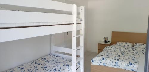 a bedroom with two bunk beds and a bed at Apartamenty Aqua in Pobierowo