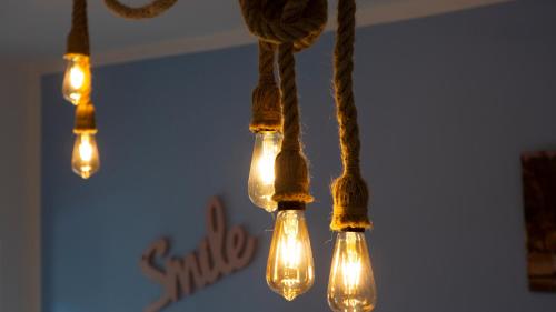 a group of lights hanging from a ceiling at Nicolaus in Sesto Calende