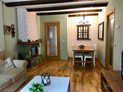 un soggiorno con un divano e un tavolo di Acogedor apartamento en el corazón del Valle a Les Bordes
