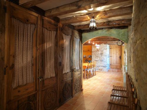 a hallway with wooden doors and a dining room at O´Porron in Sabiñánigo